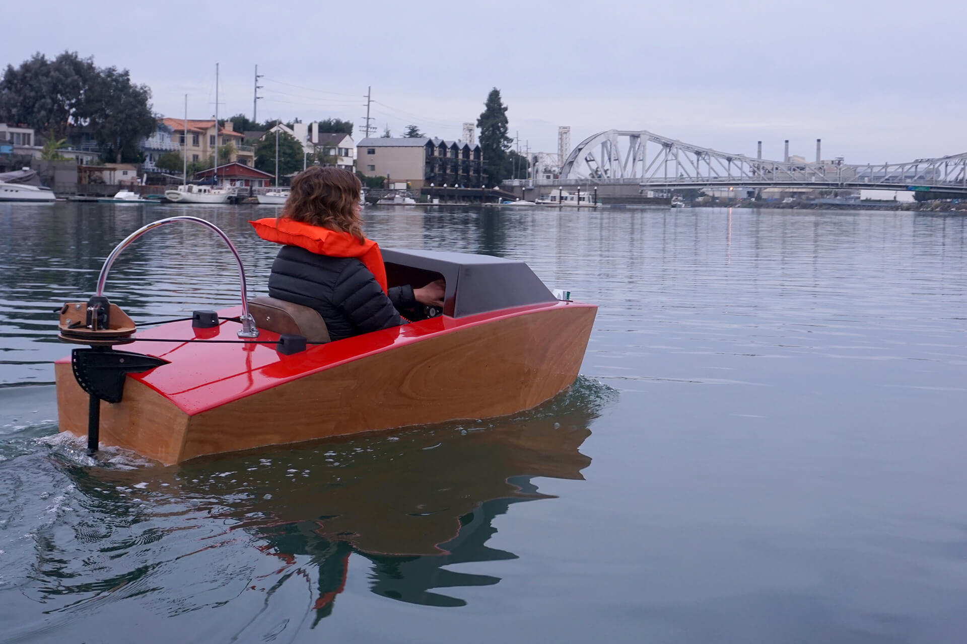 Erika riding towards the bridge at the first launch of the mini electric boat