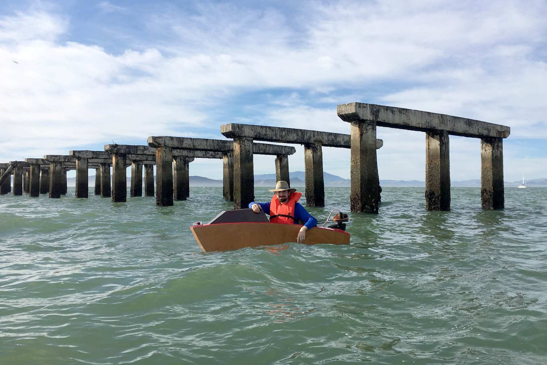 A mini boat in front of the berkeley pier ruins