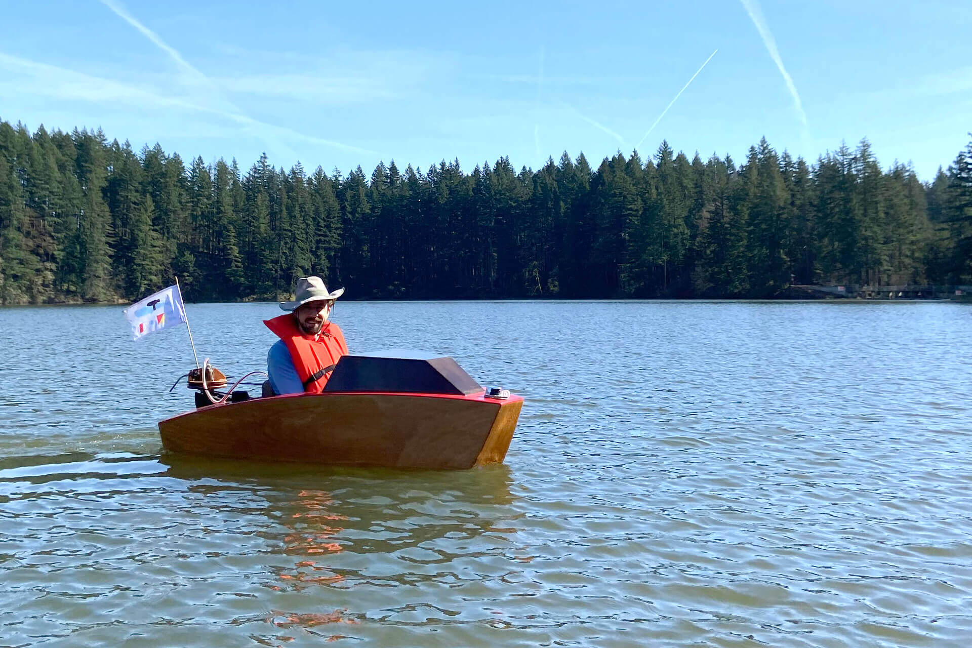 The mini boat floating in the middle of Round Lake